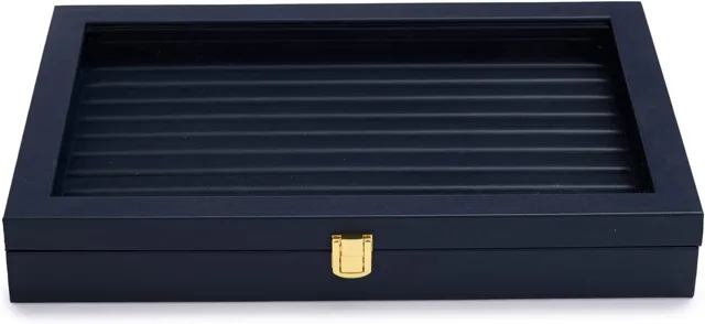 Closed navy jewelry case with a slotted ring tray visible