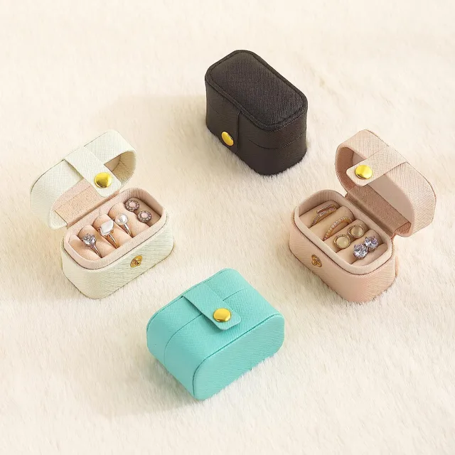 Four mini cases in blush, mint, cream and black opened together