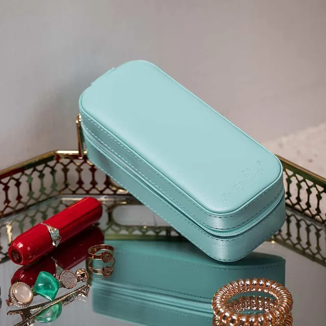 Mint zip case styled with a lipstick and bangles