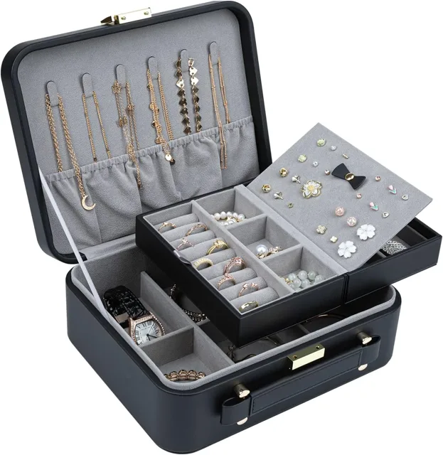 Black quilted jewelry trunk open with a grey fitted tray