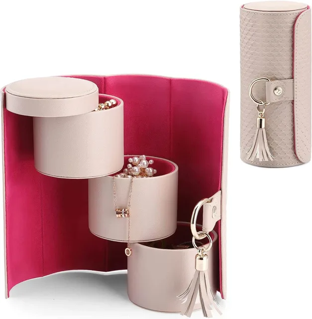 Blush pink cylinder jewelry roll unfolded into three barrels