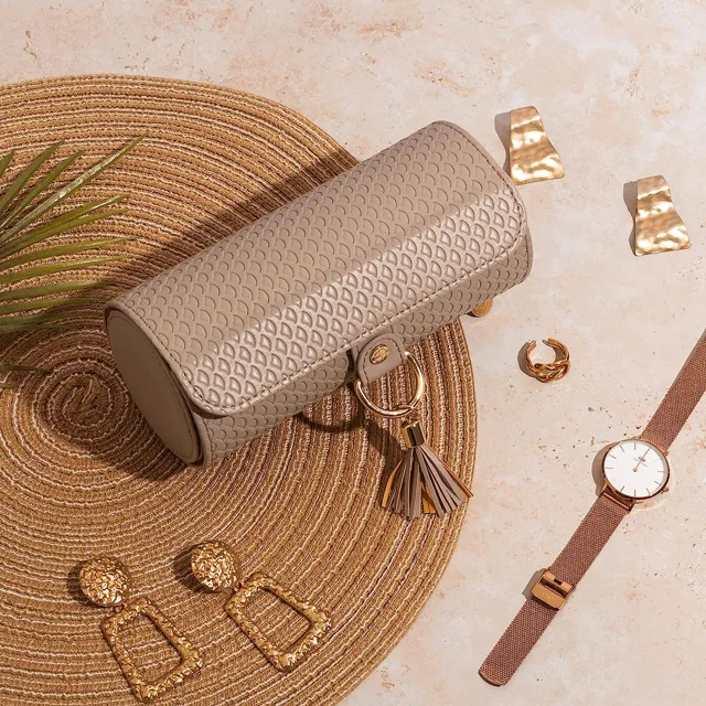 Pink roll closed on a rattan mat with jewelry around