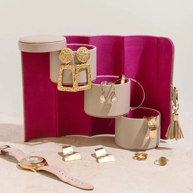 Pink roll opened to magenta lining with gold cuffs laid on