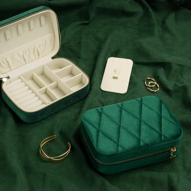 Green quilted case open on velvet with a gold bangle