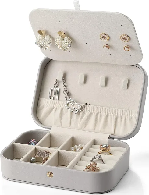 Grey travel jewelry case open with earrings and ring slots