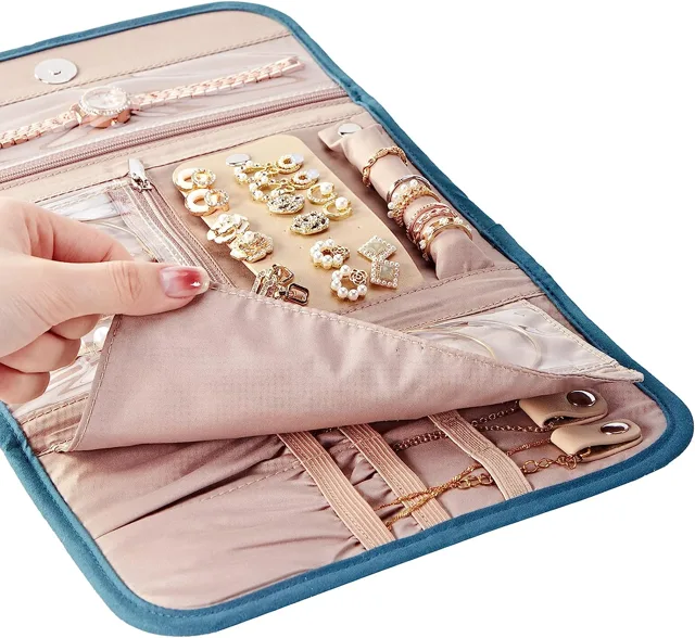 Teal jewelry organizer bag opened flat on a white background