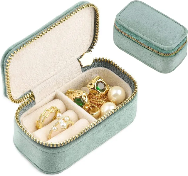 Mint green zippered jewelry case open and filled with jewelry