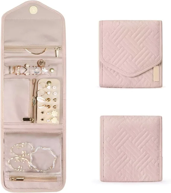 Pink jewelry roll with its removable zip pouches laid out