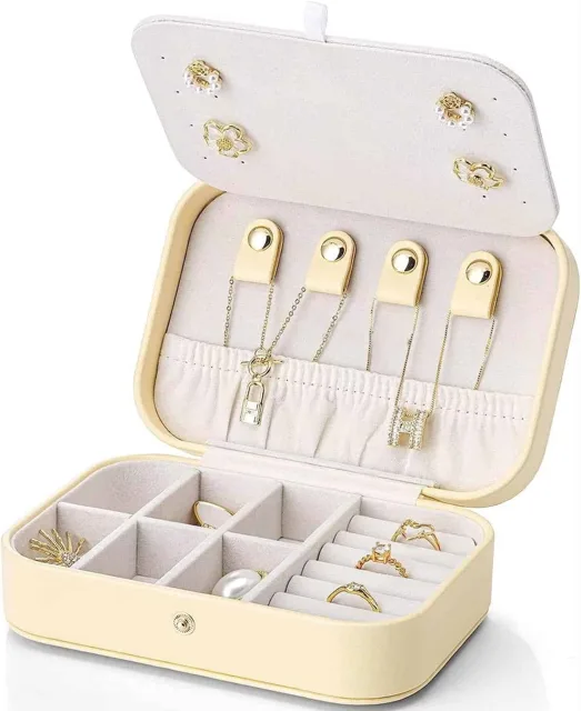 Cream travel jewelry box open showing the earring panel and tray