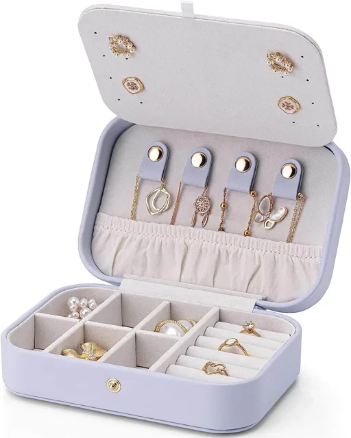 Lavender travel jewelry box open with studs on the lid panel
