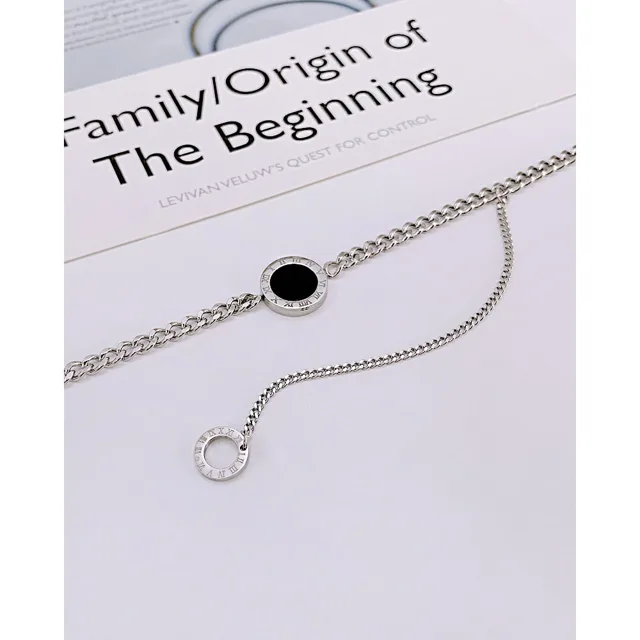 Silver clasp necklace with a black disc drop