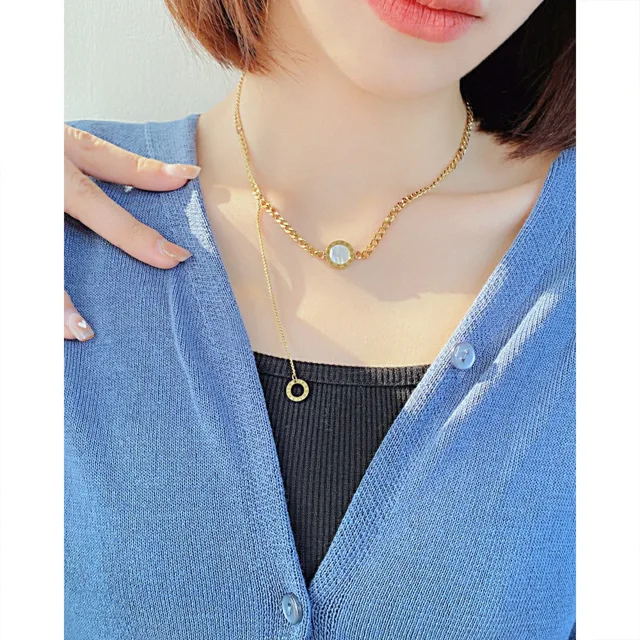 Model in blue wearing the gold clasp necklace