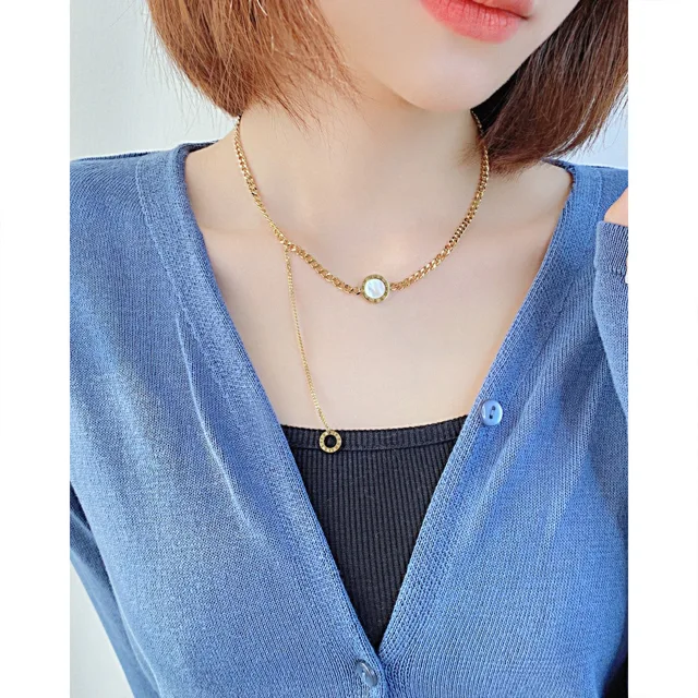 Model wearing the necklace with a green disc