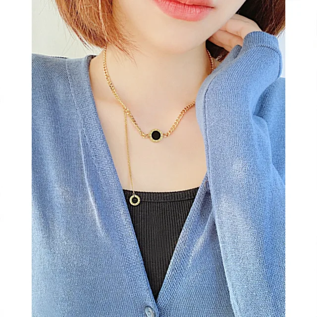 Model wearing the necklace with a black disc