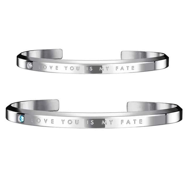 Silver open cuffs engraved with a love phrase and a blue stone