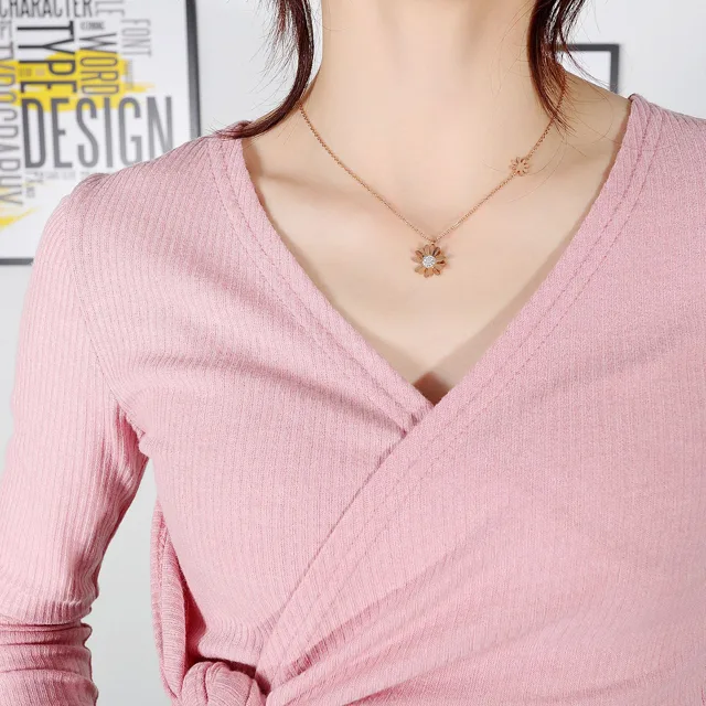 Model in pink wearing the daisy necklace