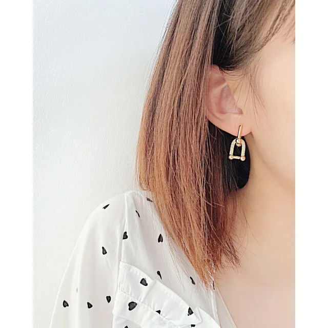 Model wearing the gold earrings, second angle