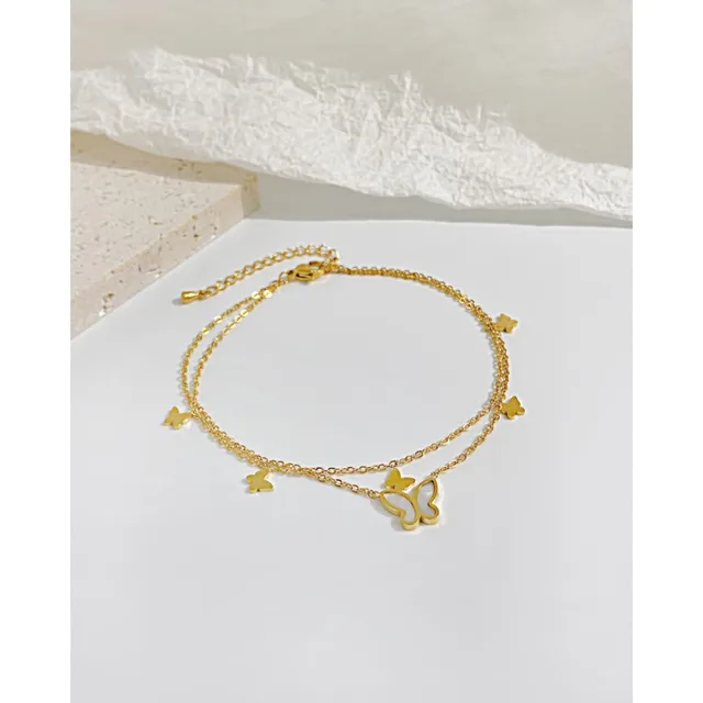 Gold anklet laid on white linen