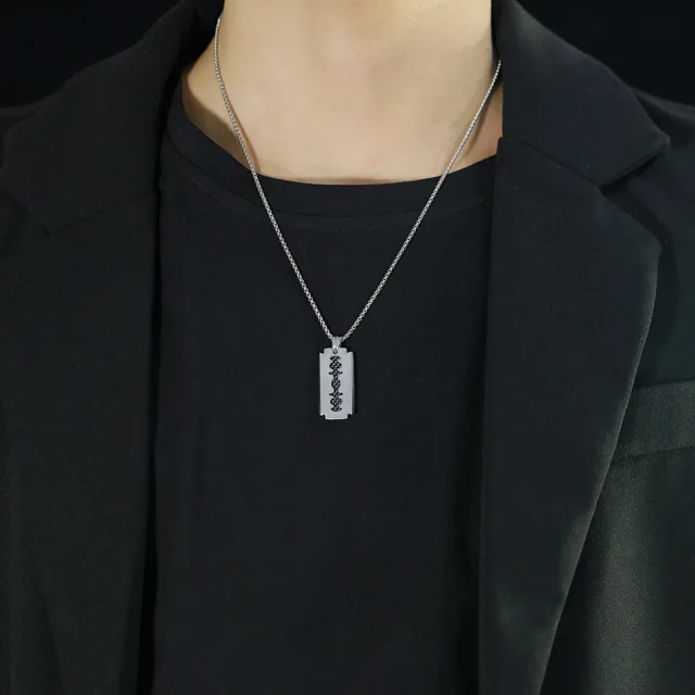 Model in black wearing the blade pendant