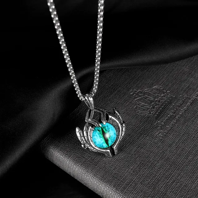 Evil eye pendant on dark stone, close view