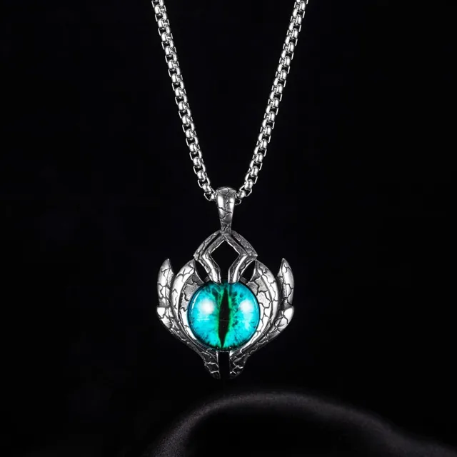 Silver evil eye pendant with a teal iris on velvet