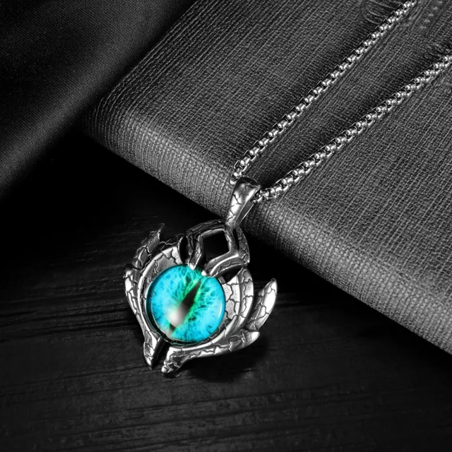 Evil eye pendant on grey fabric, close view