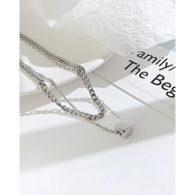 Silver layered necklace close-up on a card