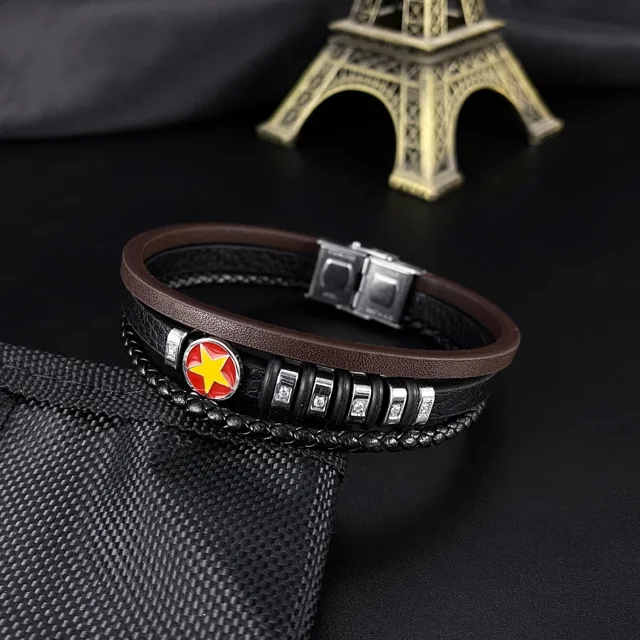Black leather bracelet styled on dark fabric
