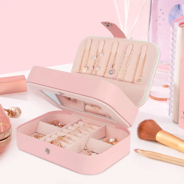 Pink mini case styled open beside makeup brushes