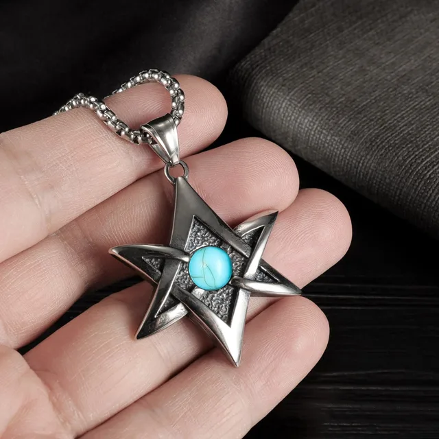 Fingers holding the star pendant, close view