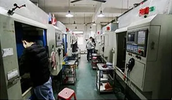 Operator running a CNC machining centre in the stainless steel jewelry workshop