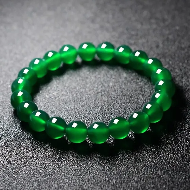 Translucent green agate stretch bead bracelet photographed on a dark background
