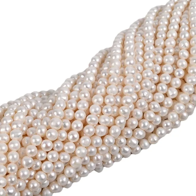 Bulk cultured freshwater pearl strands with round white pearl beads for bracelet production