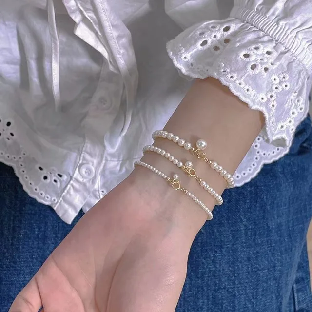 Three freshwater pearl bracelets in graduated bead sizes worn together on the wrist
