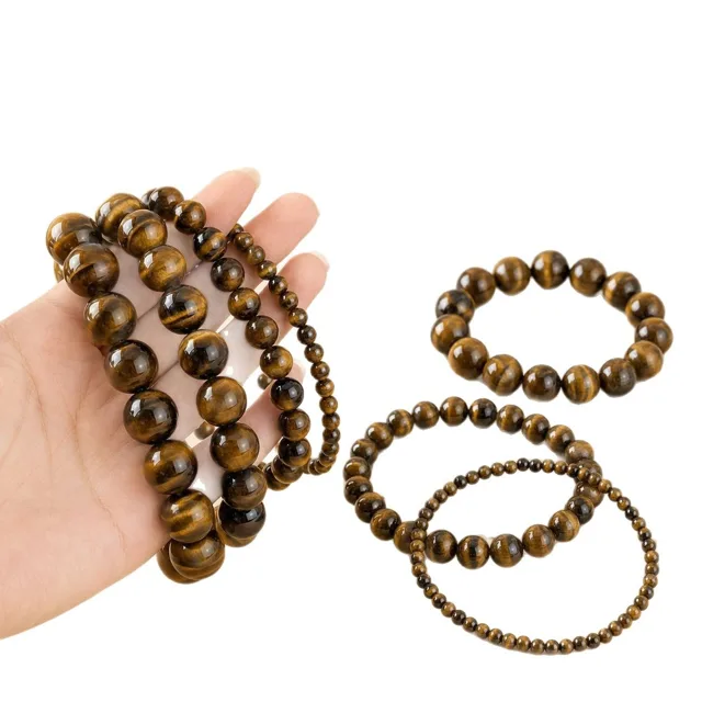 Tiger's eye stretch bracelets in graduated bead sizes on a white background