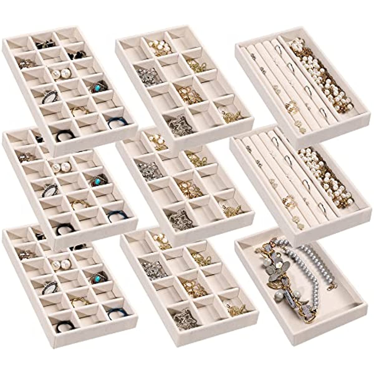 Twelve white velvet trays arranged in a flat-lay grid