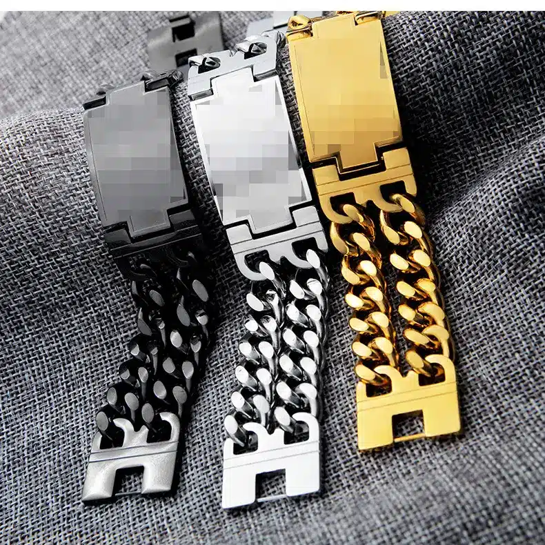 Black, gold and silver watch-band bracelets on dark fabric