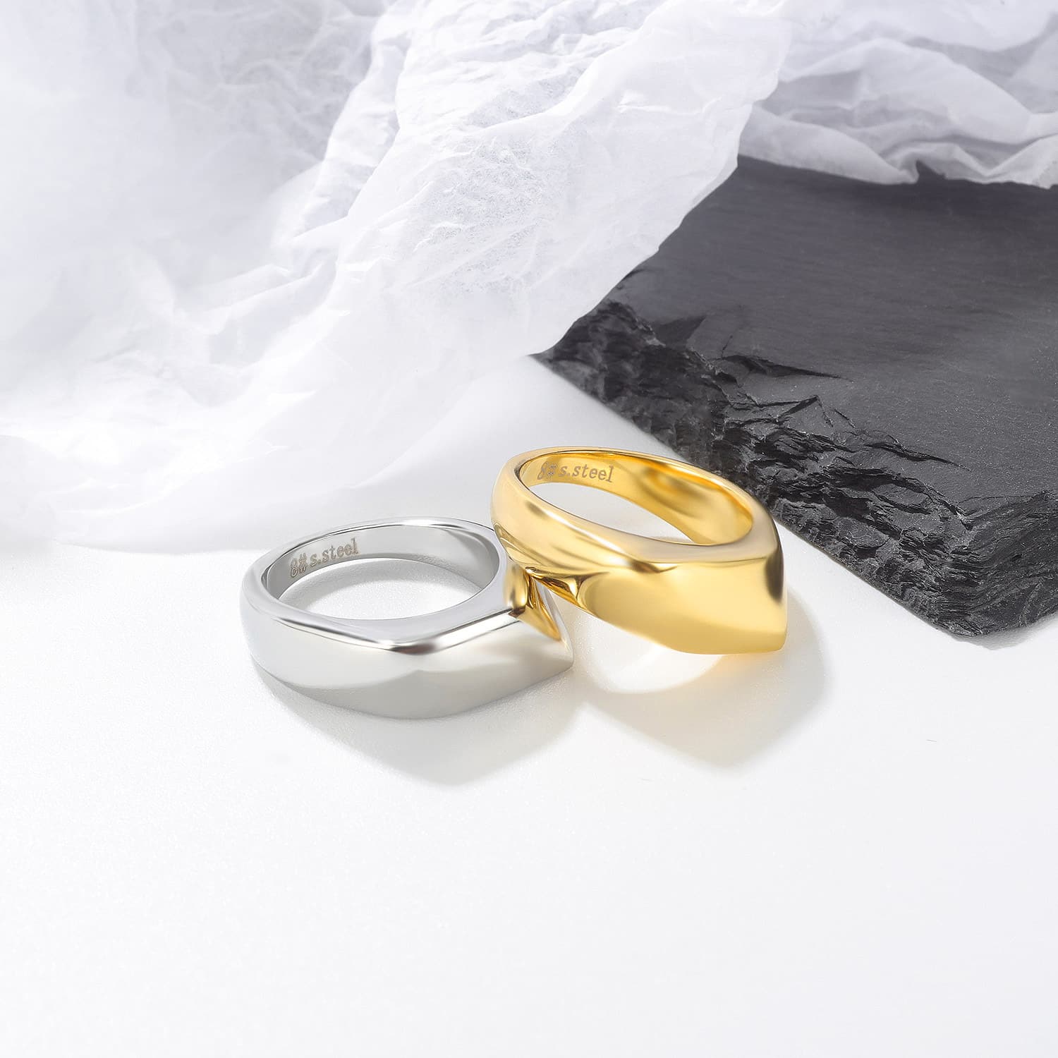 Gold and silver dome rings on a marble tray