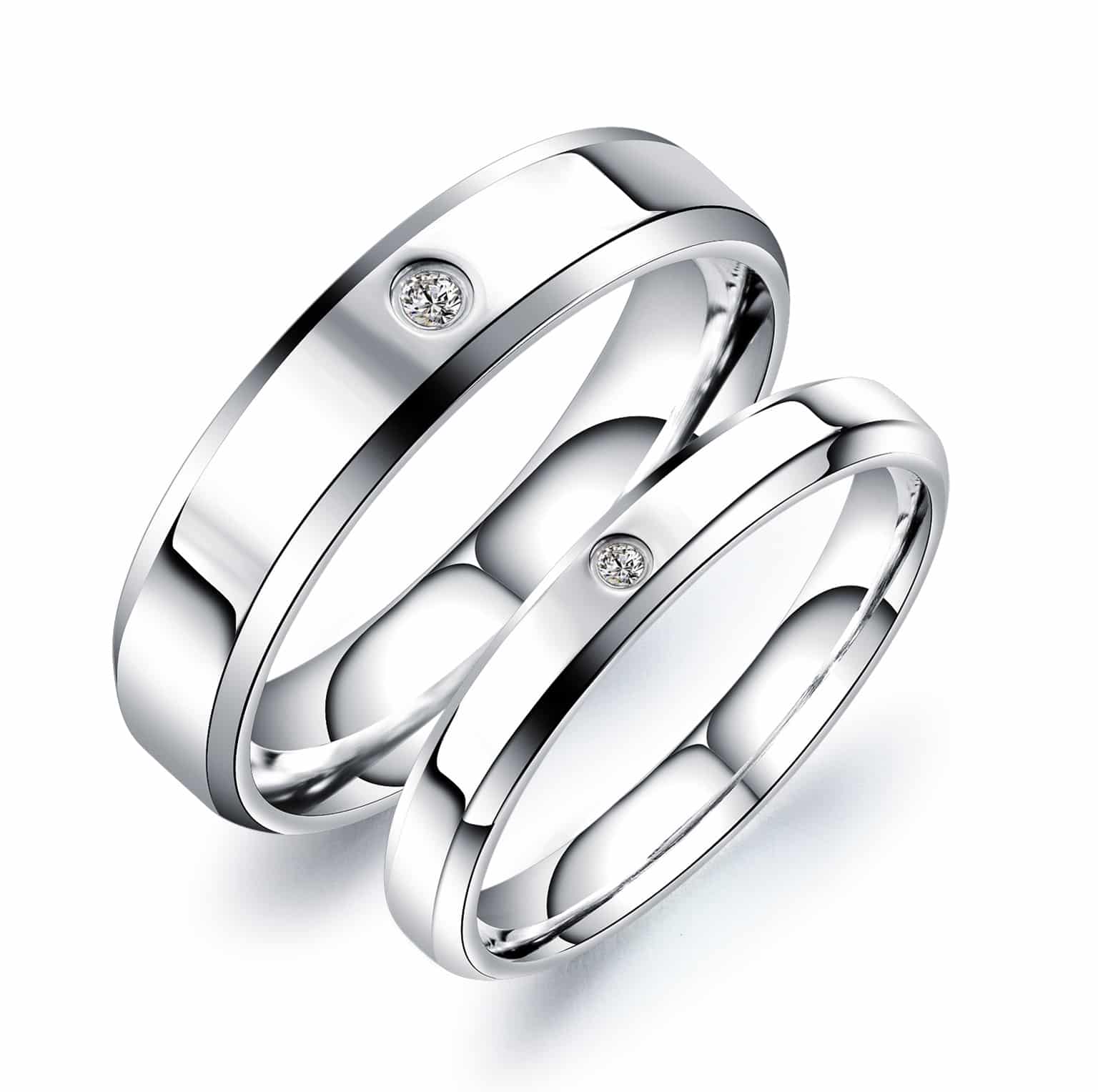 Silver wedding band pair standing crossed
