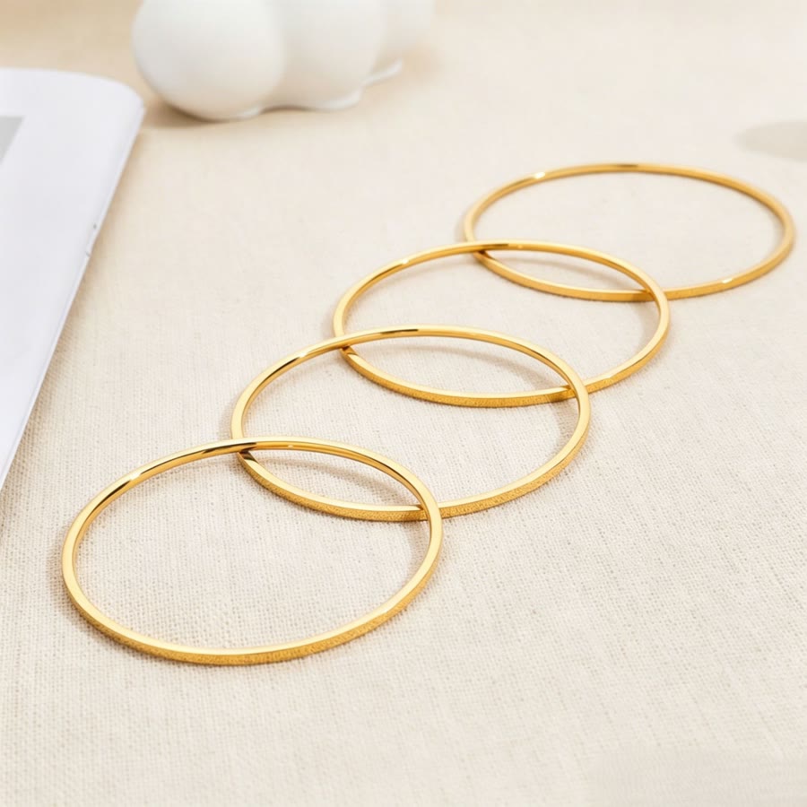 Round polished titanium steel bangle with 18k gold vacuum plating, minimalist style