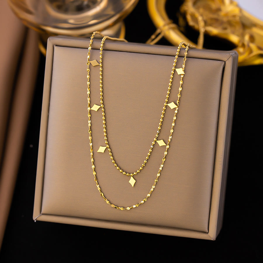 Gold double-layer necklace with small square charm drops