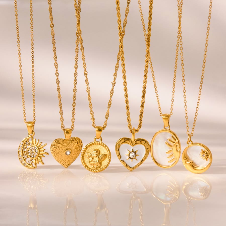 Collection of gold medallion pendants with sun, heart and angel motifs