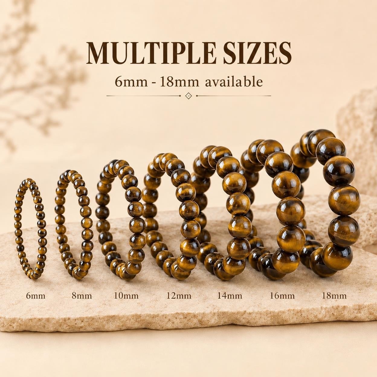 Tiger's eye bead bracelets in a size run from 6mm to 18mm displayed on a stone slab - OEM wholesale