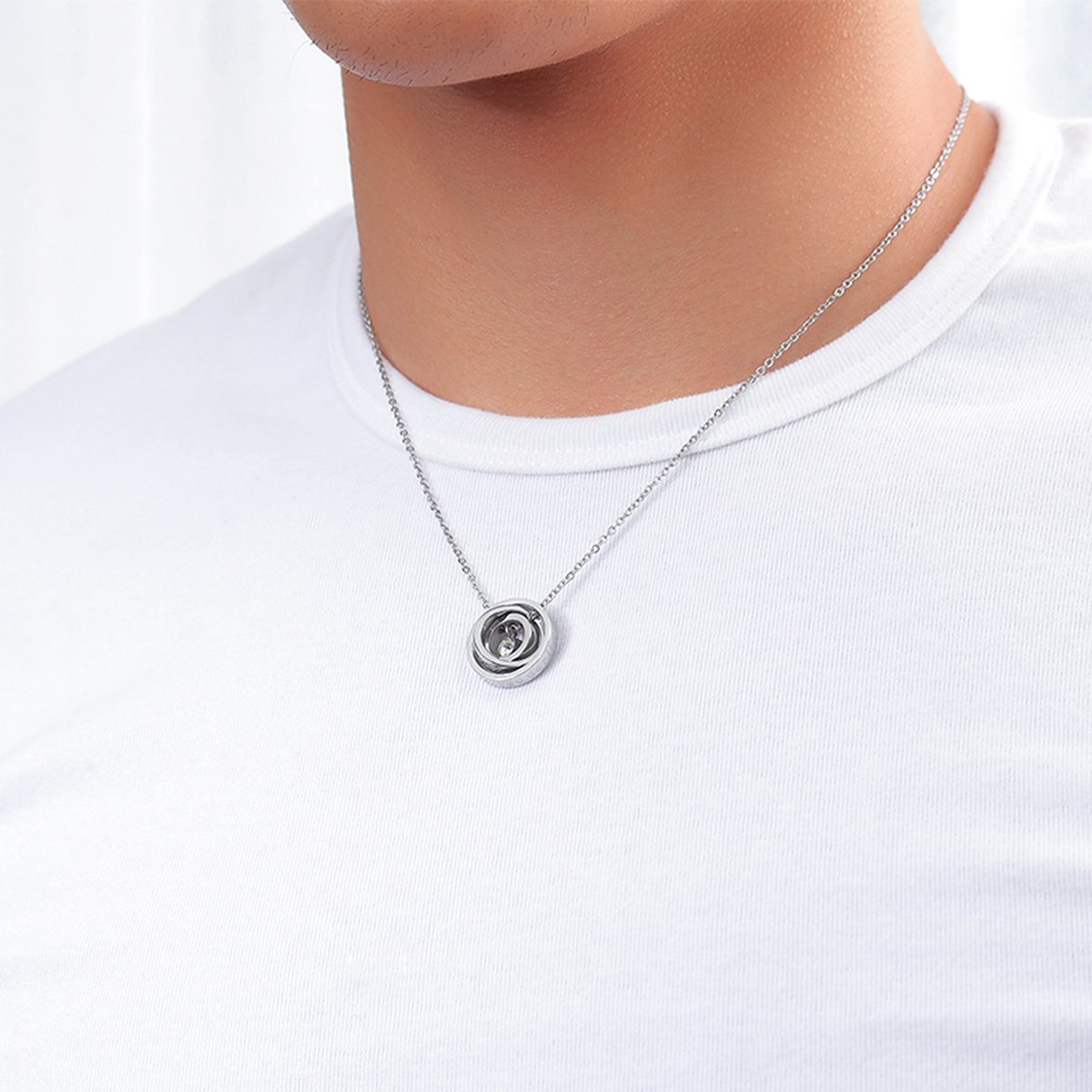 MOM rotating rings pendant necklace worn on a white t-shirt