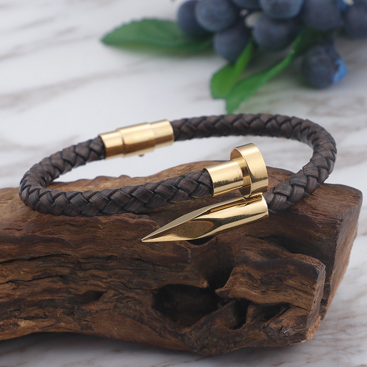 Men's leather nail bracelet lifestyle shot with grapes and wooden prop