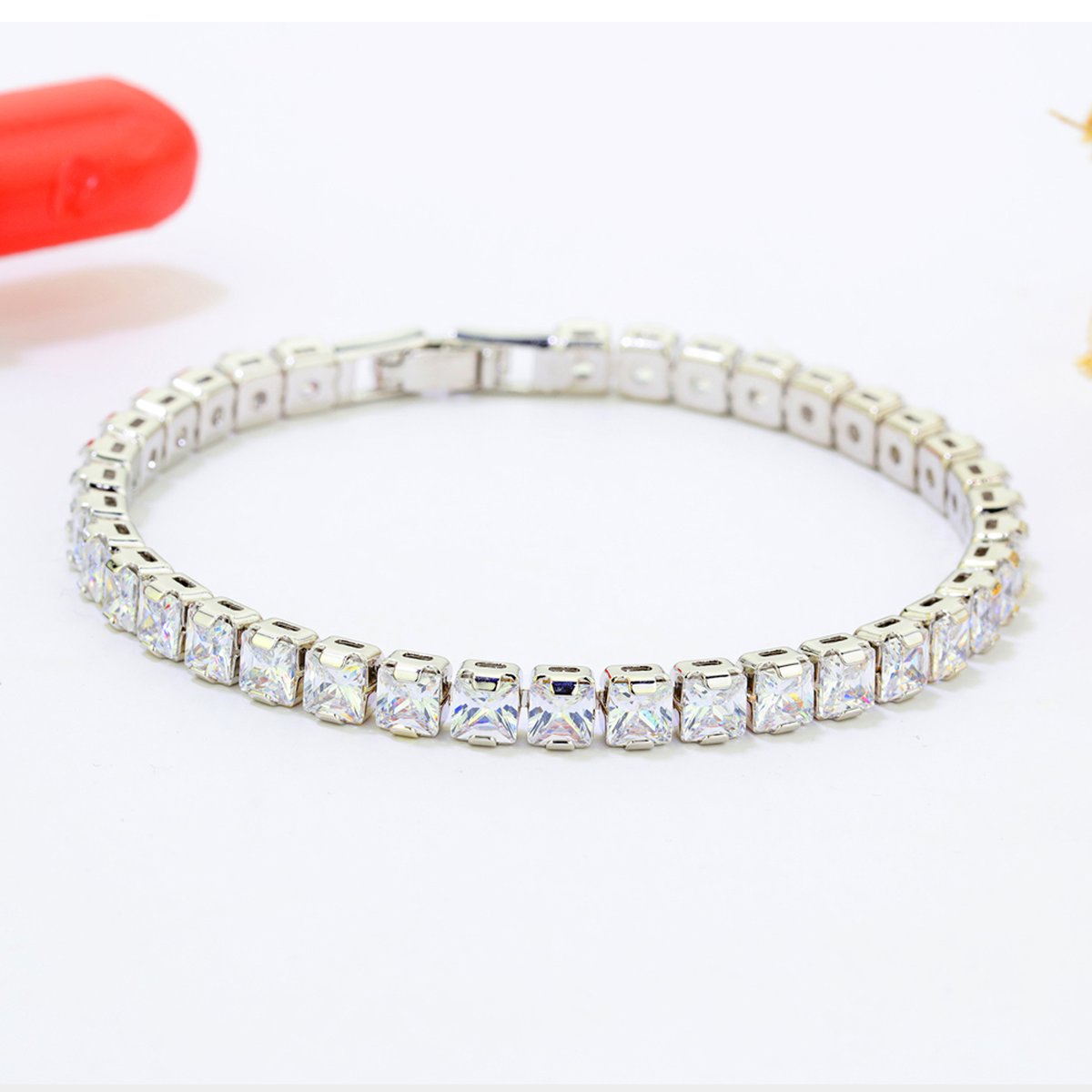 Silver square cubic zirconia tennis bracelet on white background